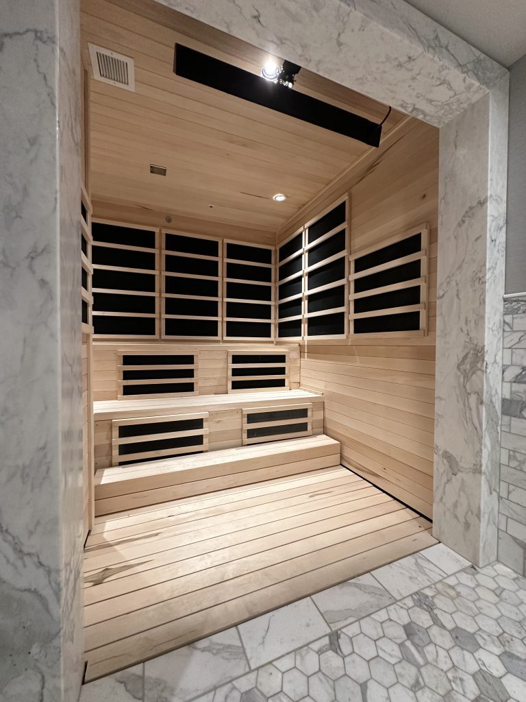 Wooden-floored sauna with marble walls