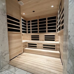 Cozy sauna with dark walls and wooden floor