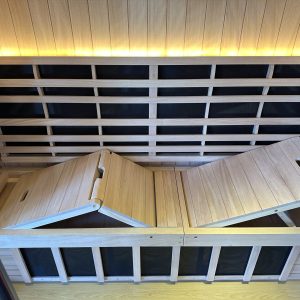 wooden sauna with two doors and a glowing light