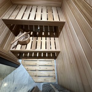 Sauna room with wooden shelves and a bench