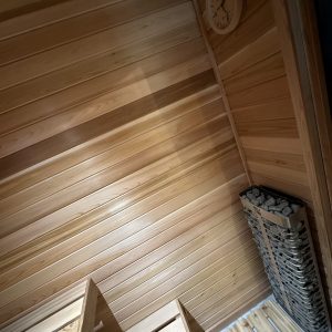 Interior of a wooden sauna with a wall clock